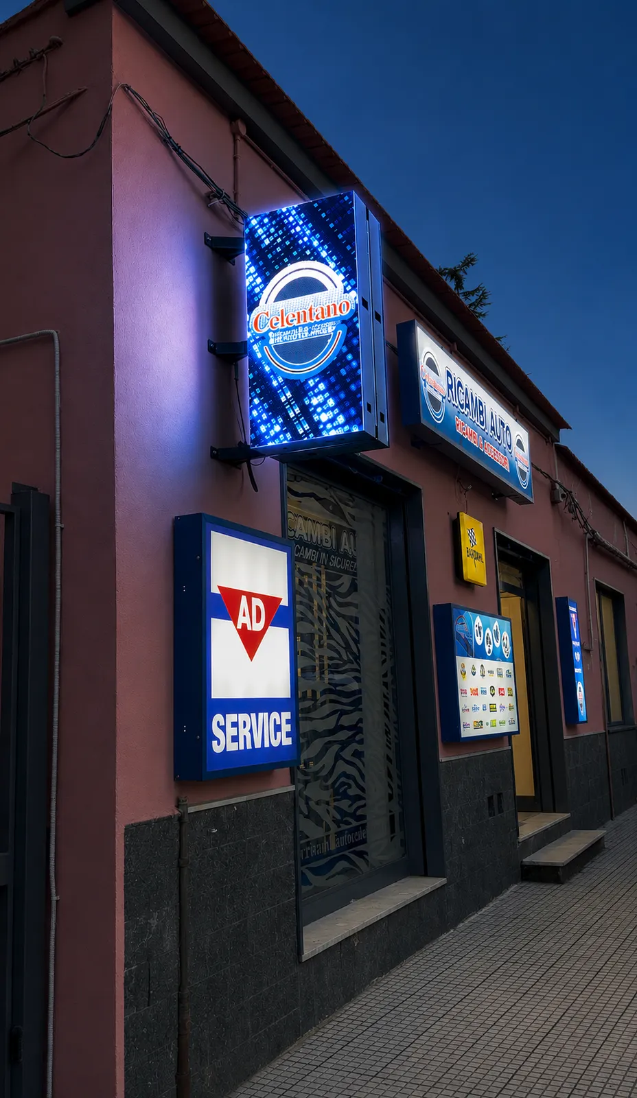 Insegna LED a bandiera su facciata, vista notturna